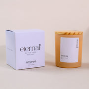 Eternal soy wax candle by Amaraa with box and wooden lid on beige background